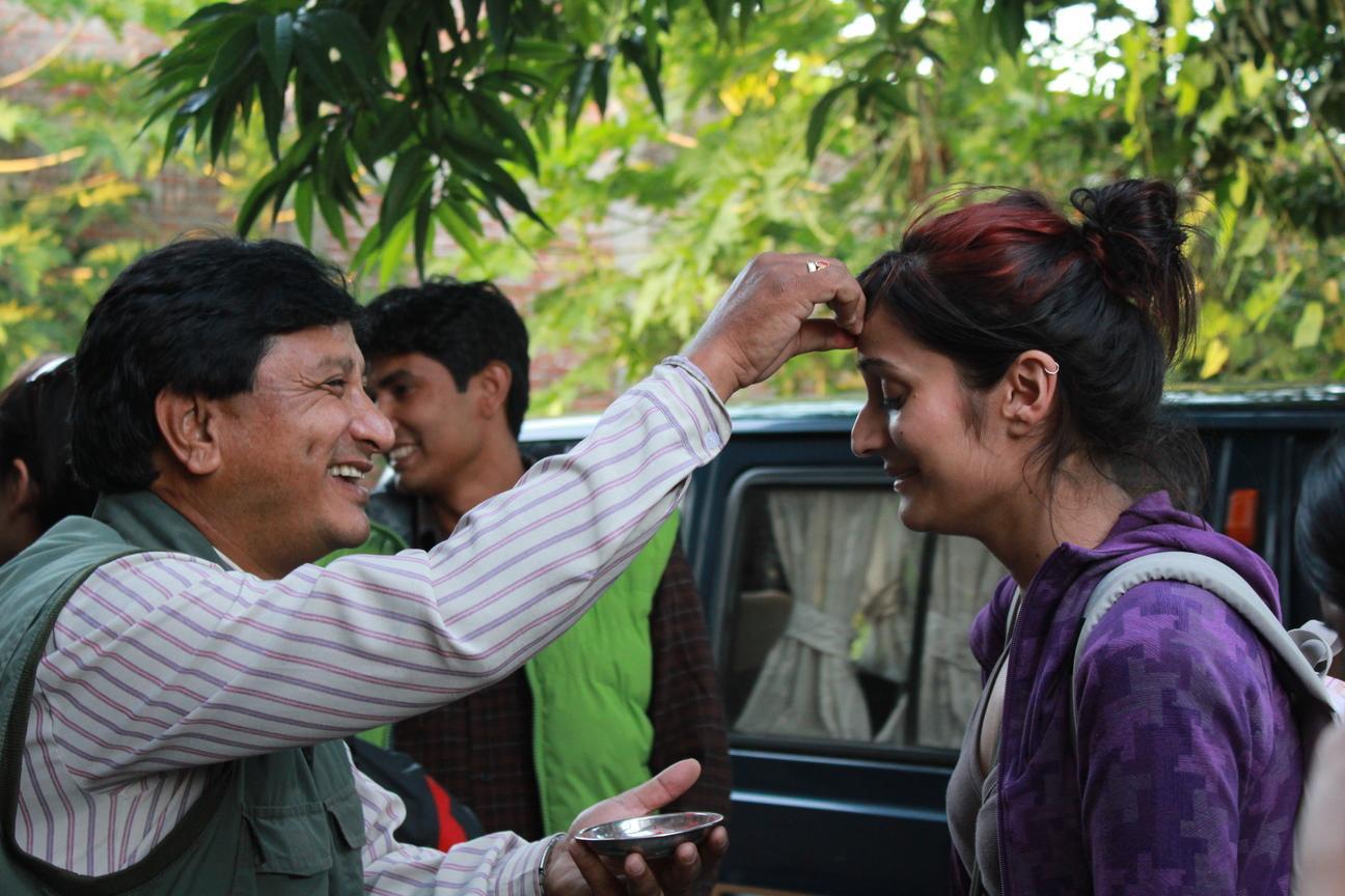 A host family meet the volunteers with a warm welcome as they arrive in Nepal. Projects Abroad volunteer get welcomed by her host family in Nepal.